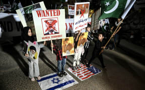 Pakistani Shiite Muslims hold placards to condemn the US-Israel attack on Iran during a protest in Karachi.