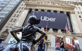 An Uber banner adorns the facade of the New York Stock Exchange ahead of the ride sharing company's IPO.