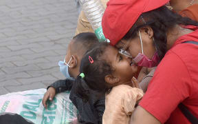 A family travelling within Delhi - many in India faced difficult situations after being separated from home and loved ones by lockdowns, disruptions, and the danger of catching Covid-19 in public spaces.
