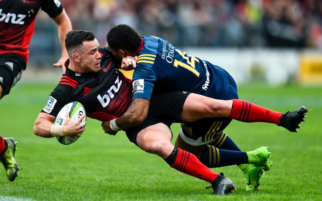 Ryan Crotty is tackled by Waisake Naholo.
