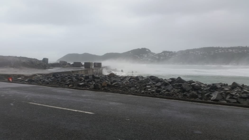 Driftwood and big waves are being washed up at Lyall Bay.