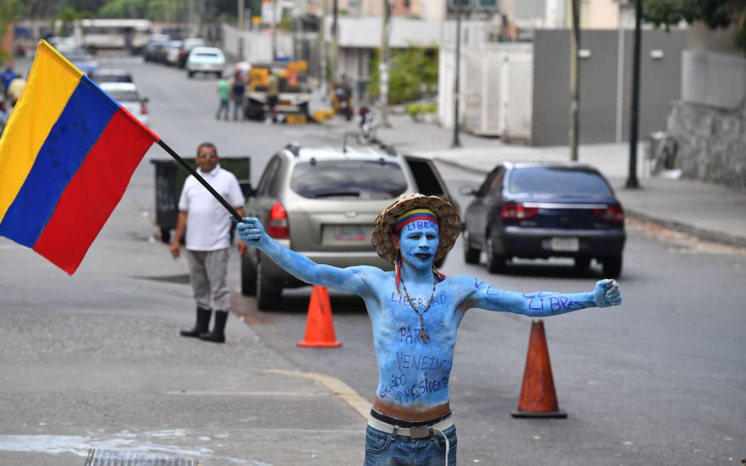 A supporter of Venezuelan opposition leader and self-proclaimed acting president Juan Guaido, demonstrates in Caracas on March 9, 2019