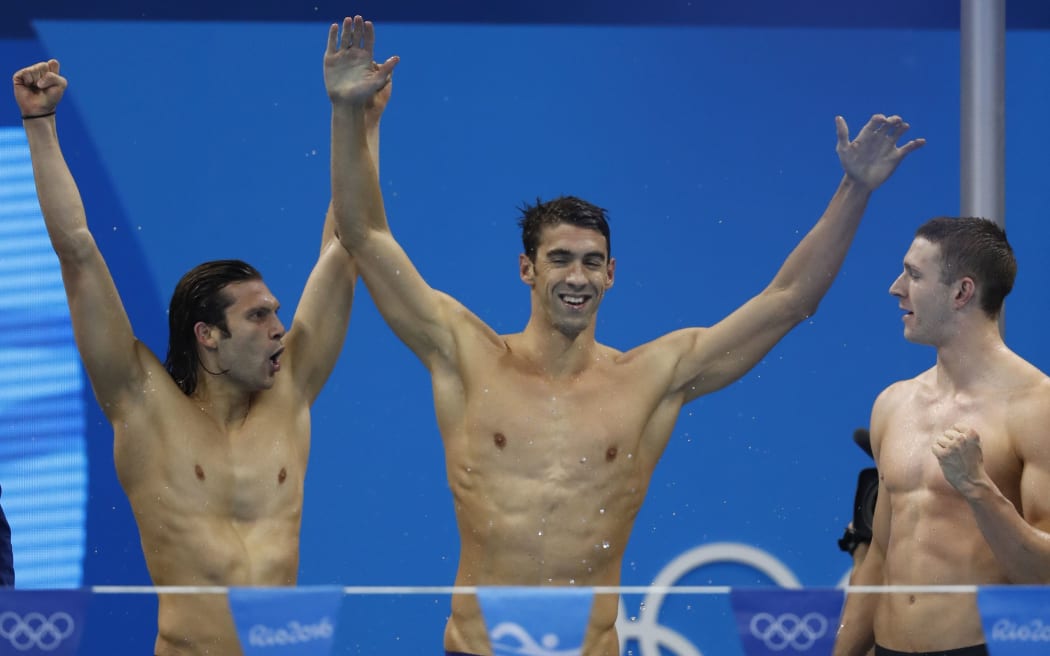 USA's Ryan Murphy (right), Cody Miller, Michael Phelps (centre) celebrate after the Men's swimming 4 x 100m Medley Relay Final at the Rio on 13 August 2016.