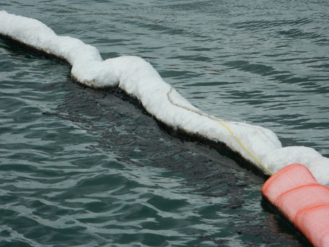 Oil on the water contained by specialised booms.