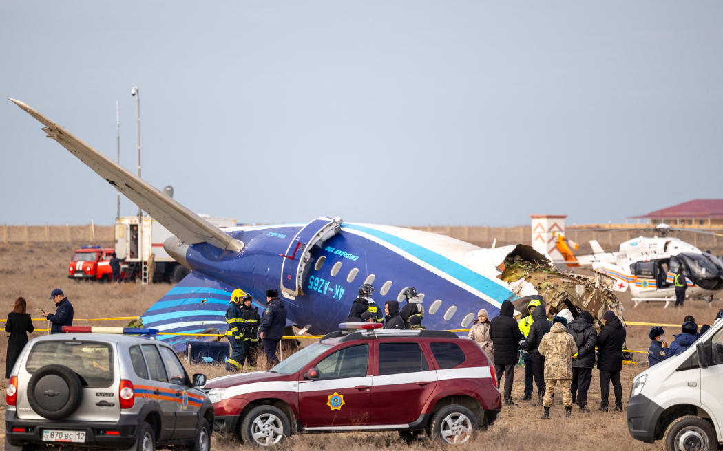 Emergency specialists work at the crash site of an Azerbaijan Airlines passenger jet near the western Kazakh city of Aktau on 25 December. (Photo by Issa Tazhenbayev / AFP)