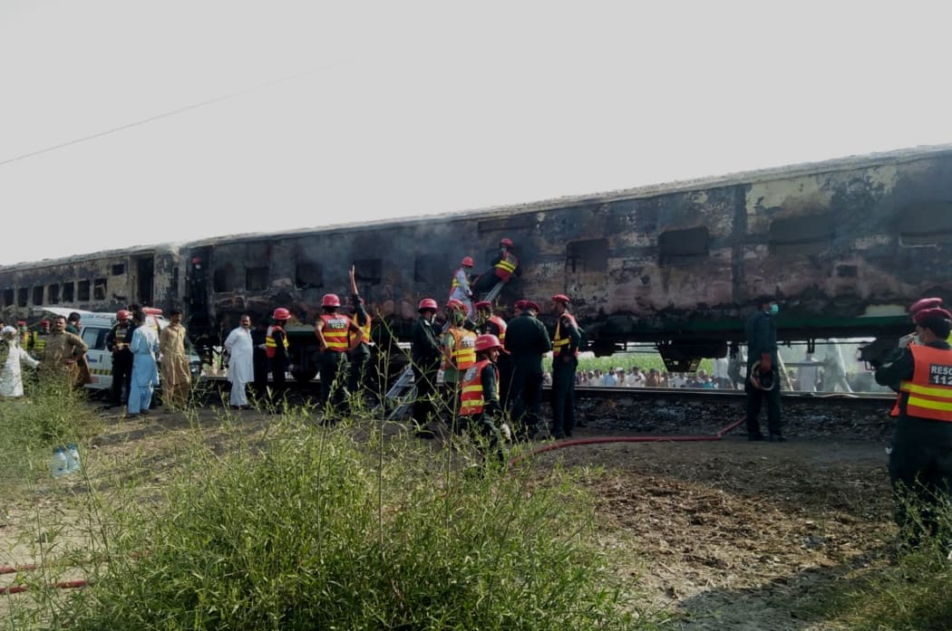 Pakistani rescuers shifting victims from a train after a fire erupted on board in southern Punjab province on 31 October, 2019.