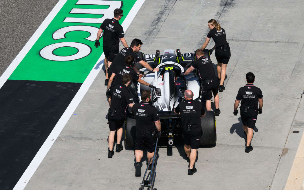 Cadillac mechanics work on their car at Formula One testing in Bahrain.