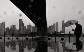 A man walks through the rain at Milsons Point in Sydney.