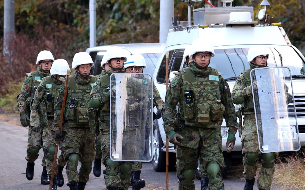 Members of the Japan Self-Defense Forces set up bear traps and are on guard against bears in Kazuno City, Akita Prefecture, Japan, on November 5, 2025. There have been a series of human casualties caused by bears in Akita Prefecture and other parts of Japan.( The Yomiuri Shimbun ) (Photo by Hidenori Nagai / The Yomiuri Shimbun via AFP)