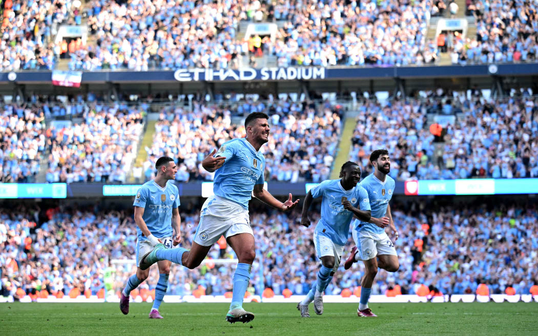 Manchester City's Spanish midfielder #16 Rodri (L) celebrates scoring the team's third goal during the English Premier League football match between Manchester City and West Ham United at the Etihad Stadium in Manchester, north west England, on May 19, 2024. (Photo by Oli SCARFF / AFP) / RESTRICTED TO EDITORIAL USE. No use with unauthorized audio, video, data, fixture lists, club/league logos or 'live' services. Online in-match use limited to 120 images. An additional 40 images may be used in extra time. No video emulation. Social media in-match use limited to 120 images. An additional 40 images may be used in extra time. No use in betting publications, games or single club/league/player publications. /