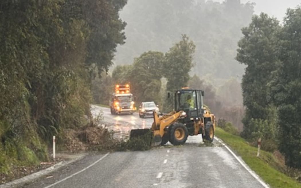 Rockfall from a slip is being cleared off the road near Jacksons on State Highway 73