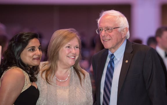 US Democratic presidential candidate Bernie Sanders and his wife Jane pose for a picture with a guest at the correspondent’s dinner.