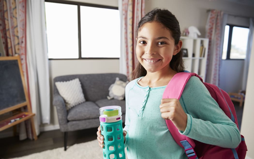 A Portrait Of Girl With Backpack In Bedroom Ready To Go To School