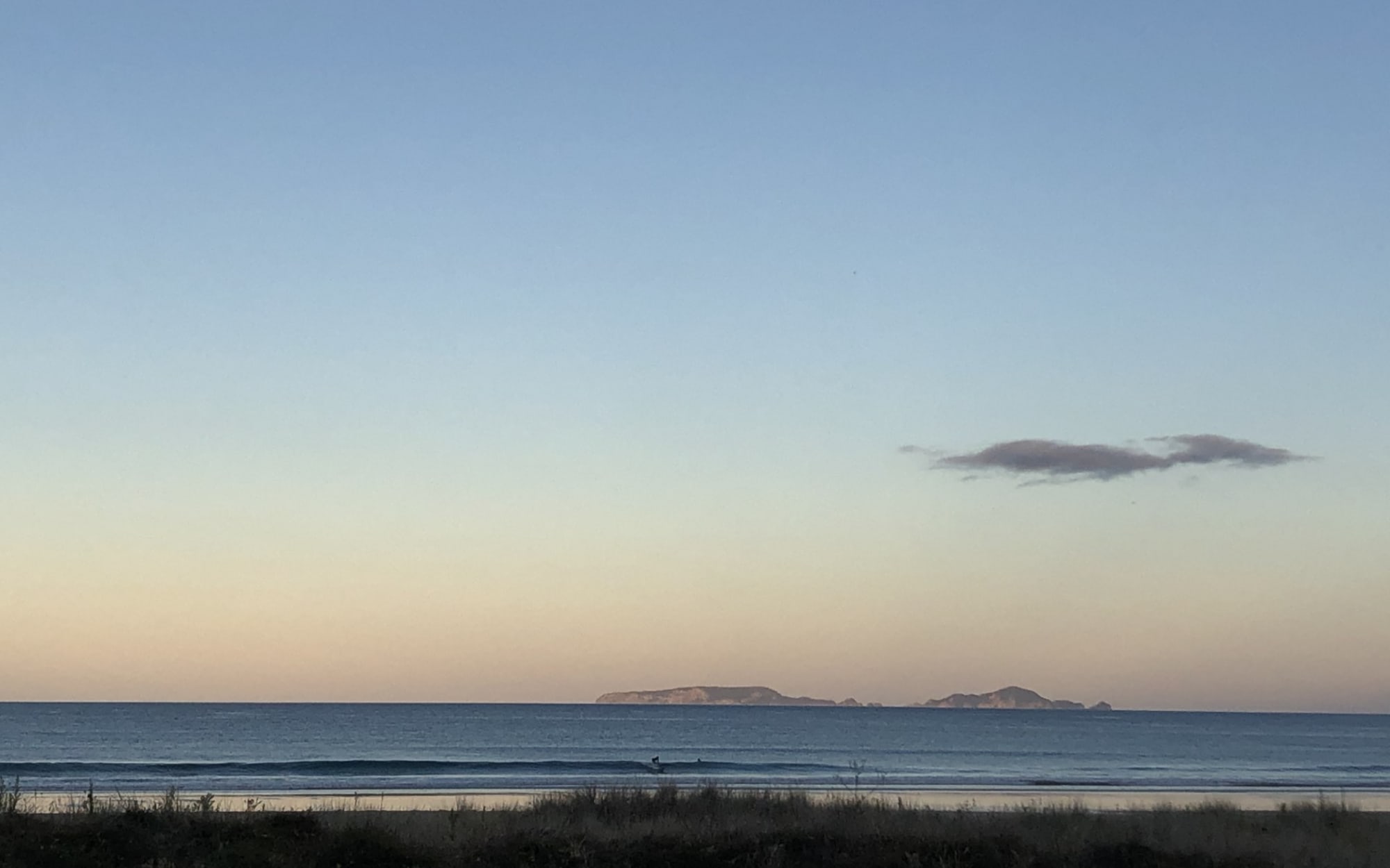 The Poor Knights Islands at dusk, seen from Sandy Bay, Northland.