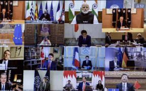 Australian Prime Minister Scott Morrison (Top-R) is seen on a screen attending a videoconference with G20 leaders to discuss the COVID-19 coronavirus, at the Parliament House in Canberra on March 26, 2020.