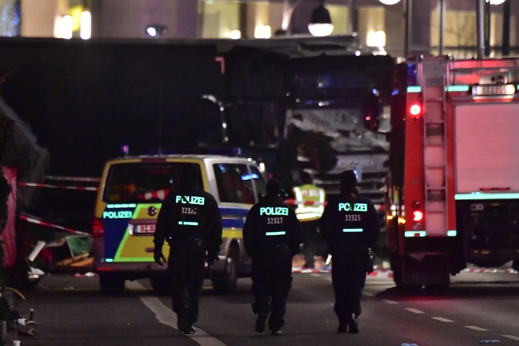 Police walk before the truck that had sped into a Christmas market in Berlin, on 19 December 2016.