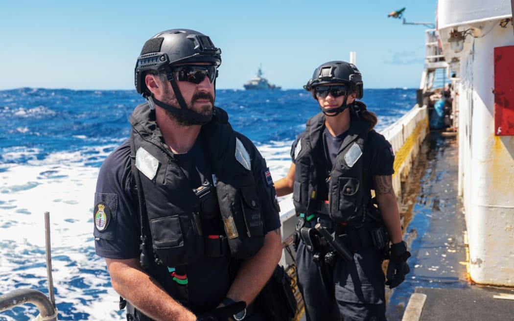 Petty Officer Seaman Combat Specialist Jordan McHugh and Able Hydrographic Systems Operator Mya-Marie Wells on board a vessel of interest