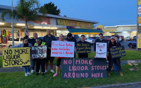 Members of Communities Against Alcohol Harm protesting outside a liquor store in Ōtara.