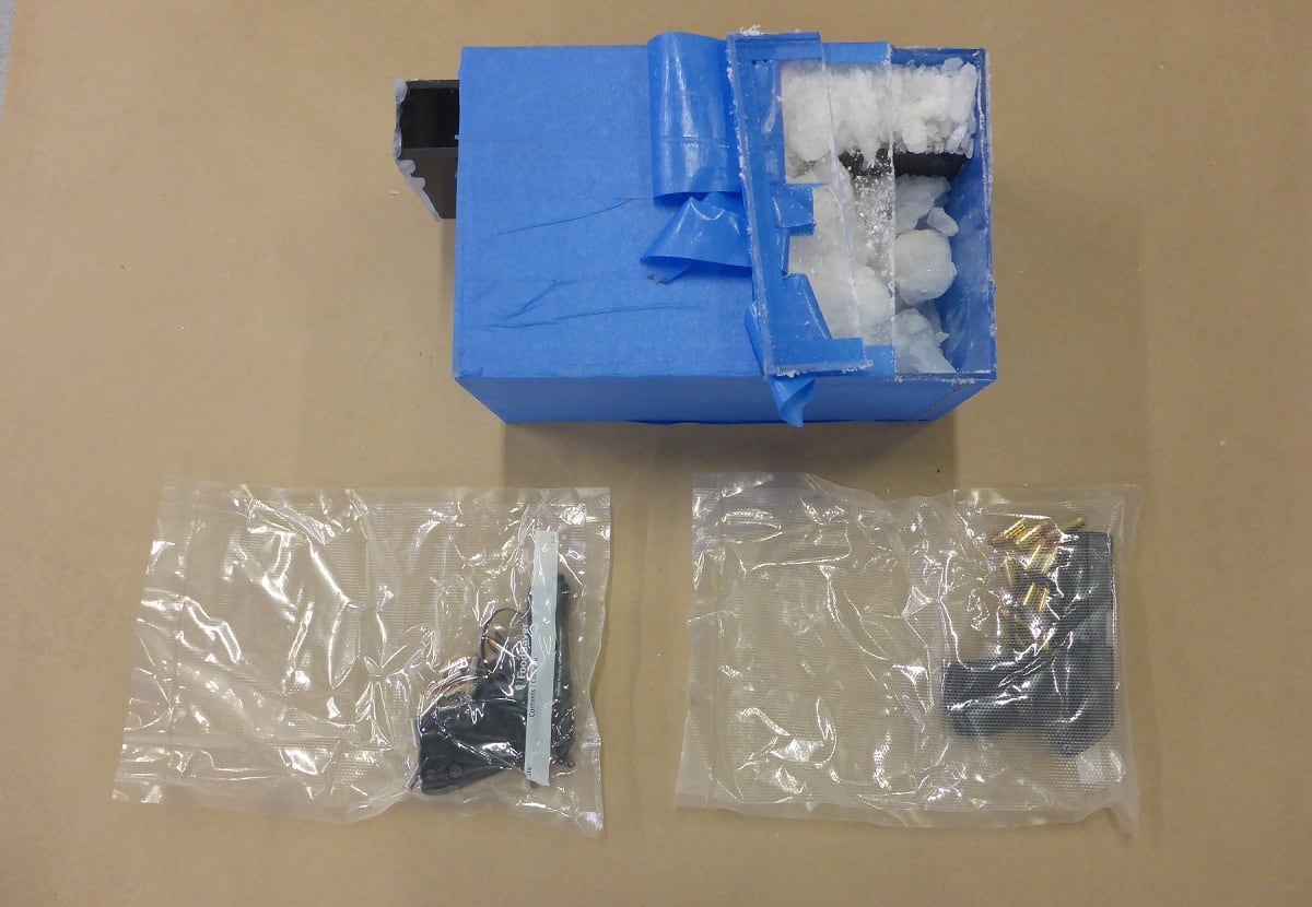 Closeup of methamphetamine and handguns.