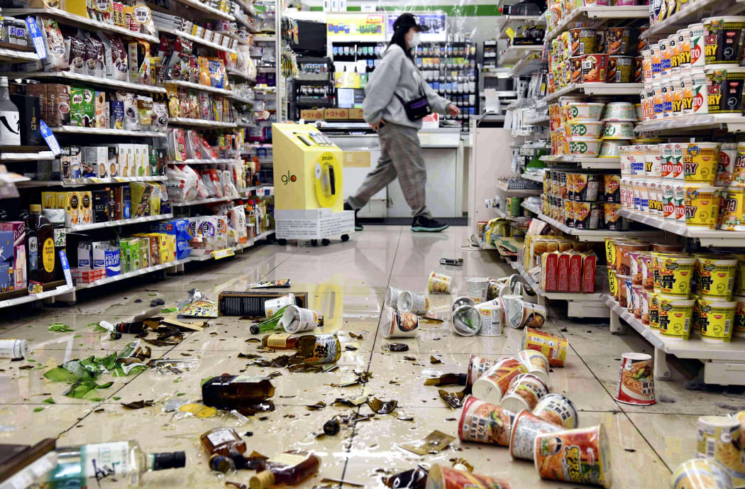 Fallen bottles and other products at a convenience store in Fukushima City, Fukushima prefecture on March 16, 2022.