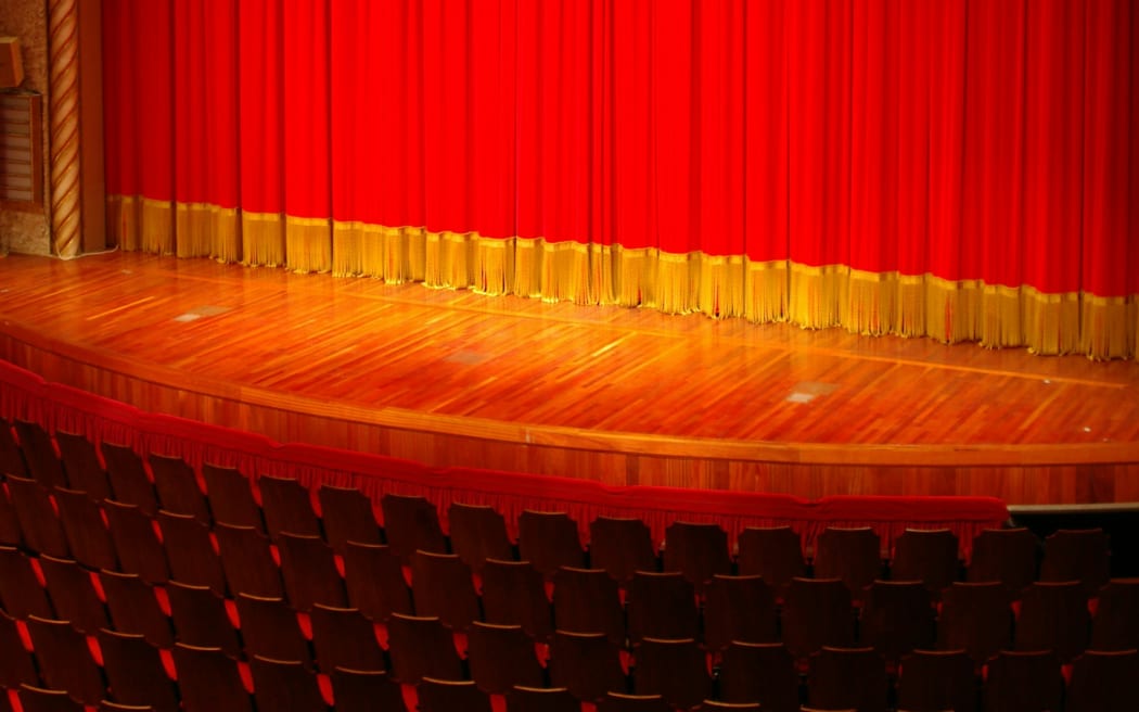 theatre stage, red seats, front stage