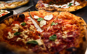 Pizza is seen at pizzeria in Milan, Italy on March 2, 2025.