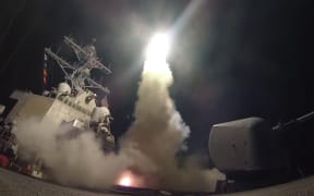 A Tomahawk missile is launched from the USS Ross during a military strike on a Syrian airbase.