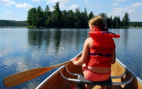 Girl in canoe wearing lifejacket