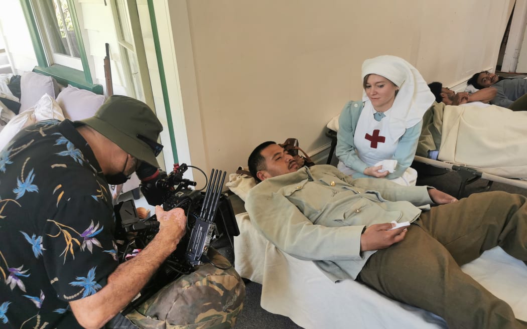 A nurse tends to a wounded soldier (dramatic re-enactment).