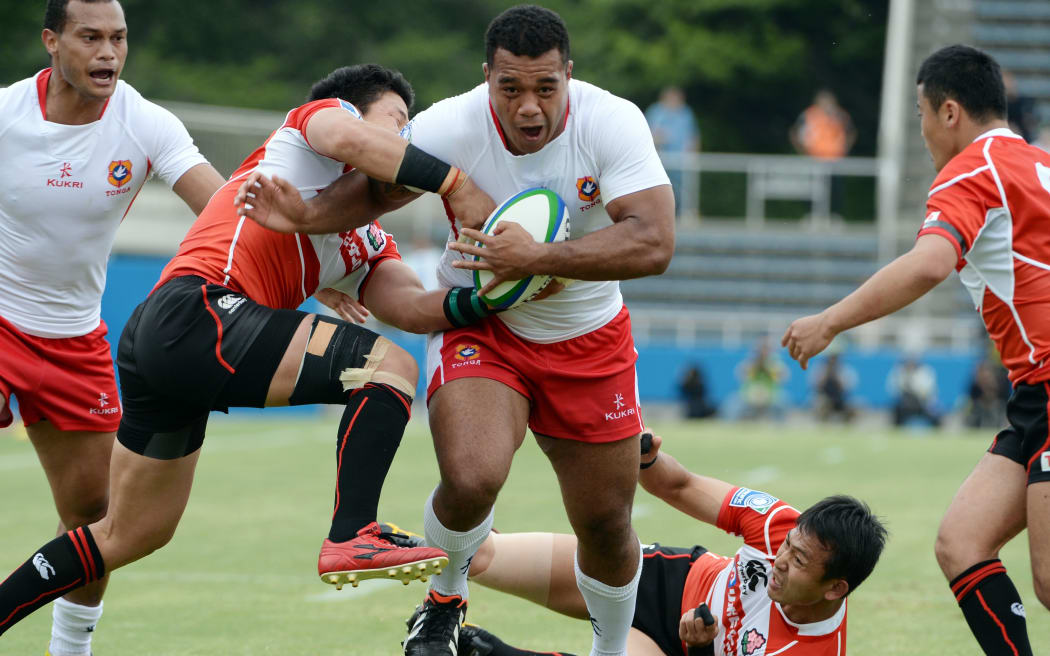 Tonga's Taione Vea is tackled on test debut against Japan in 2013.