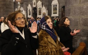 Christian worshippers attend Christmas Eve Mass at the Cathedral of Our Lady of the Dormition, known also as the Olive Church, in Damascus, on December 24, 2024. - Syria's rulers who toppled Assad's government on December 8 have since sought to assure religious and ethnic minorities that their rights would be upheld. But for some in the Christian community of several hundred thousands, the promises made by the new Islamist leadership have done little to soothe their fears in a country scarred by years of civil war. (Photo by ANWAR AMRO / AFP)
