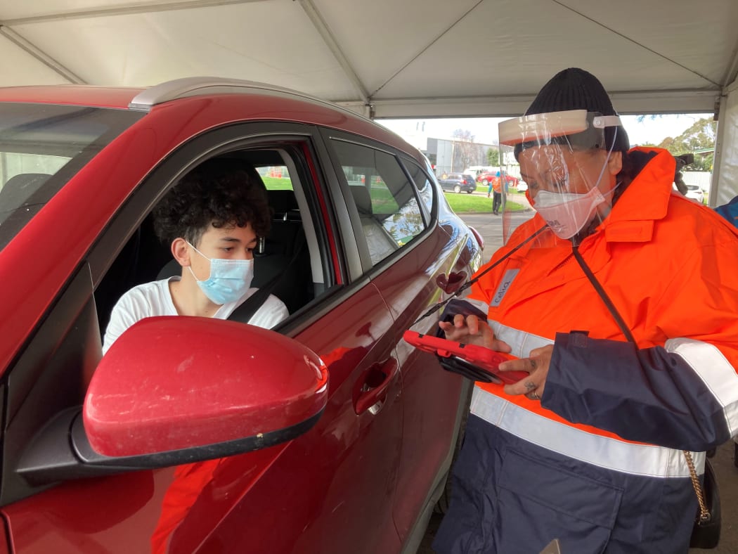 Te Rangiura Royal with his mum Matire Harwood at Auckland's first drive-thru vaccination site.