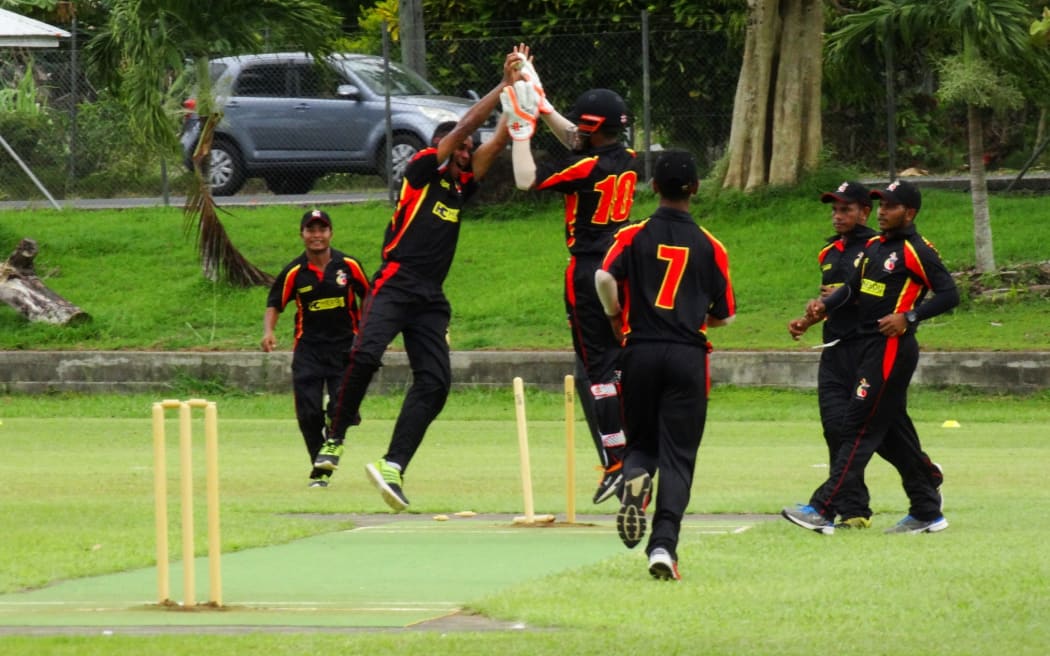 The PNG Garamuts celebrate a wicket in their win over Fiji.