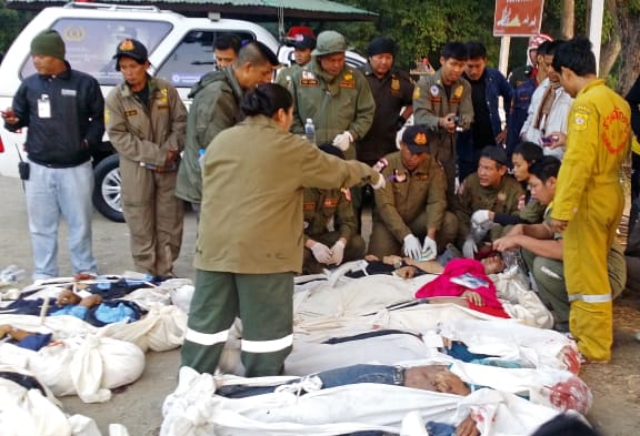 Thai police count the bodies after a bus plunged off a bridge in Phetchabun province.