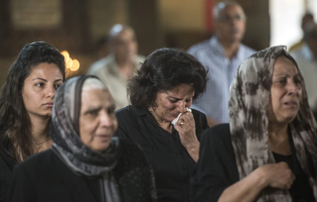 Relatives and friends of the cabin crew and passengers, who were on board the EgyptAir plane that crashed in the Mediterranean, attend a mourning ceremony on May 22, 2016 at the Saint Peter and Saint Paul Coptic Orthodox Church in the Abbasiya district of the Egyptian capital Cairo.