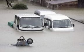 Vehicles submerged in water in Noda City, Chiba.