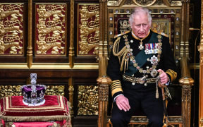 Charles, then pictured as Prince of Wales (right) by the The Imperial State Crown in the House of Lords Chamber, in the Houses of Parliament, in London, on May 10, 2022.