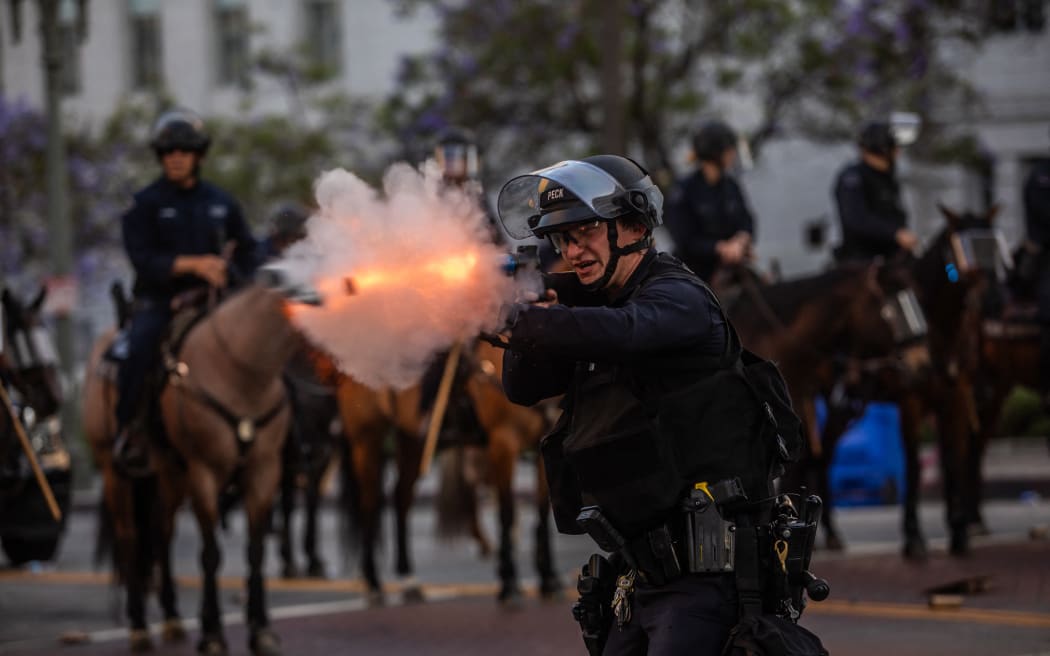 LAPD officers shoot rubber bullets at protesters in front of the City Hall in Los Angeles, California.