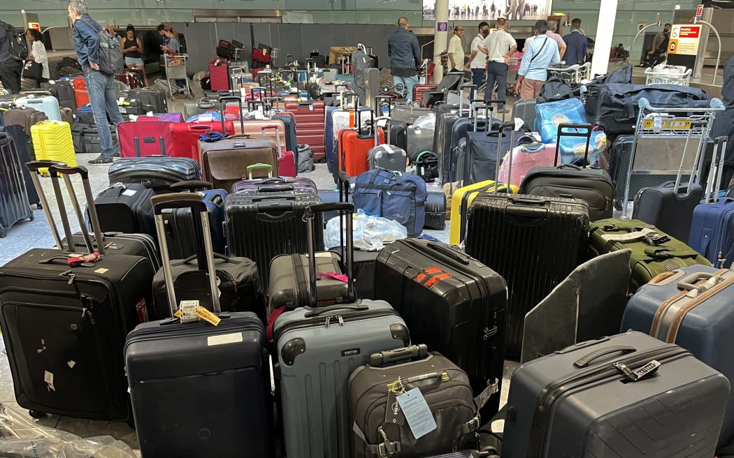 Suitcases are seen uncollected at Heathrow's Terminal Three bagage reclaim, west of London on July 8, 2022. - British Airways on Wednesday axed another 10,300 short-haul flights up to the end of October, with the aviation sector battling staff shortages and booming demand as the pandemic recedes. (Photo by Paul ELLIS / AFP)