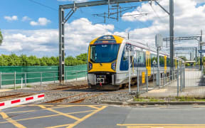 A train approaches a level crossing.