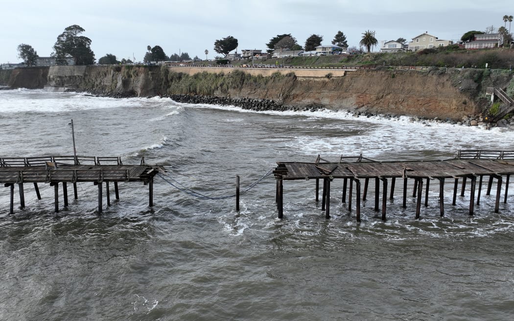 CAPITOLA, CALIFORNIA - JANUARY 06: In an aerial view, damage is visible on the Capitola Wharf following a powerful winter storm on January 06, 2023 in Capitola, California. A powerful storm pounded the West Coast this weeks that uprooted trees and cut power for tens of thousands on the heels of record rainfall over the weekend. Another powerful storm is set to hit Northern California over the weekend and is expected to bring flooding rains.   Justin Sullivan/Getty Images/AFP (Photo by JUSTIN SULLIVAN / GETTY IMAGES NORTH AMERICA / Getty Images via AFP)