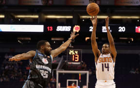 De'Anthony Melton of the Phoenix Suns attempts a shot over Patrick Richard of the New Zealand Breakers.