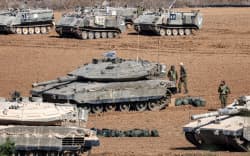 Israeli army Merkava battle tanks and other vehicles deploy along the border with the Gaza Strip in southern Israel on October 13, 2023. Thousands of people, both Israeli and Palestinians have died since October 7, 2023, after Palestinian Hamas militants entered Israel in a surprise attack leading Israel to declare war on Hamas in the Gaza Strip enclave on October 8. (Photo by JACK GUEZ / AFP)