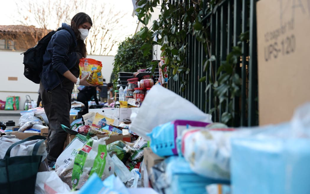 PASADENA, CALIFORNIA - JANUARY 10: A resident collects donated pet items from the Pasadena Humane Society on January 10, 2025 in Pasadena, California. Hundreds of pets have been displaced by the Eaton Fire and many residents have had to shelter their pets at the Pasadena Humane Society. The Eaton Fire has grown to over 13,000 acres and has destroyed over 5,000 homes and businesses. Five people have lost their lives in the fire.   Justin Sullivan/Getty Images/AFP (Photo by JUSTIN SULLIVAN / GETTY IMAGES NORTH AMERICA / Getty Images via AFP)