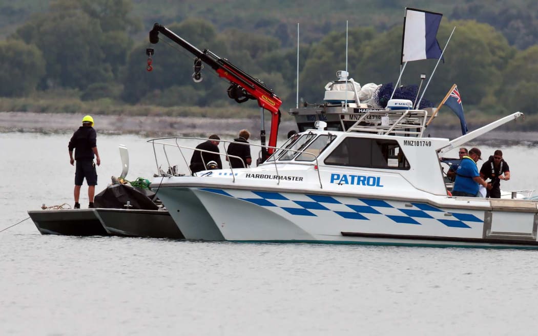 Divers recover the engine from the downed plane.