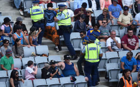 Police take away fans during the Twenty20 match between the Black Caps and Sri Lanka at Eden Park.