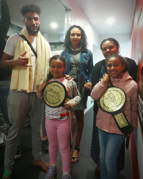 Hayellom Tesfay, with his mother and sisters