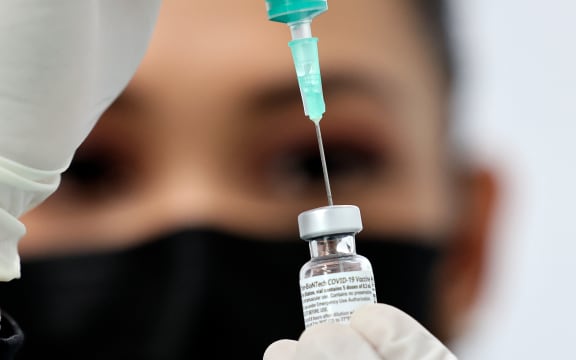 A health worker prepares an injection of the Pfizer-BioNTech vaccine against the coronavirus at a vaccination centre, set up at the Dubai International Financial Centre.