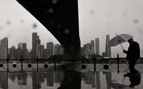 A man walks through the rain at Milsons Point in Sydney.