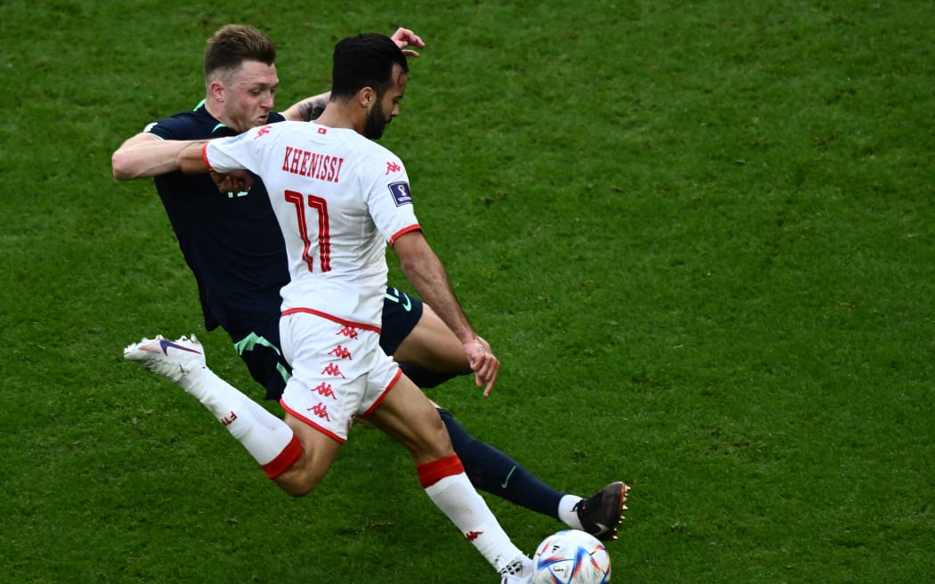 Australia's defender Harry Souttar (L) fights for the ball with Tunisia's forward #11 Taha Khenissi (R) during the Qatar 2022 World Cup Group D football match between Tunisia and Australia at the Al-Janoub Stadium in Al-Wakrah, south of Doha on 26 November, 2022.